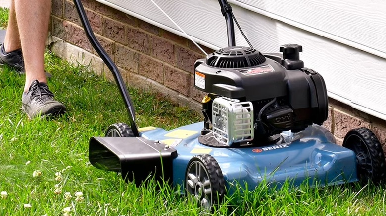 Landscaper using a Senix mower near the edge of a building