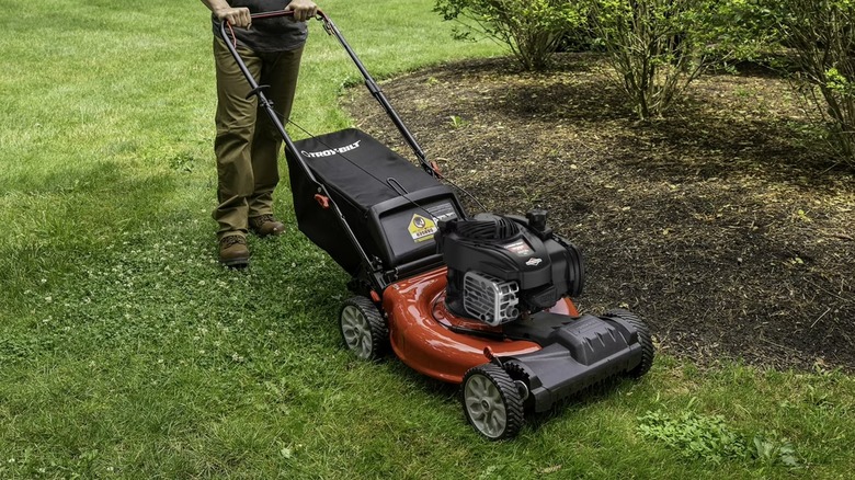 Landscaper mowing around a curved edge with Troy-Bilt mower