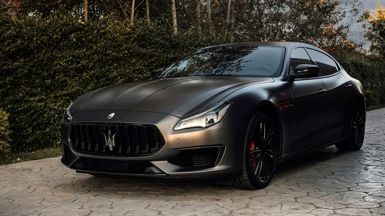A Maserati Quattroporte parked on a stone path