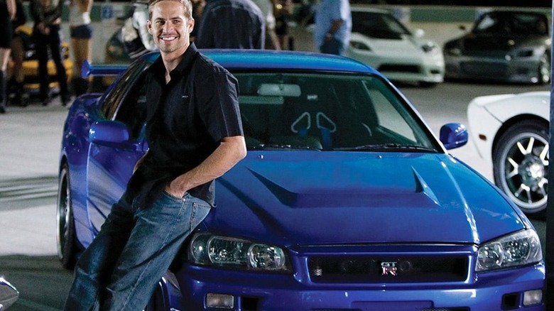 Brian leaning against his 2000 Nissan Skyline GT-R in "The Fast and the Furious"