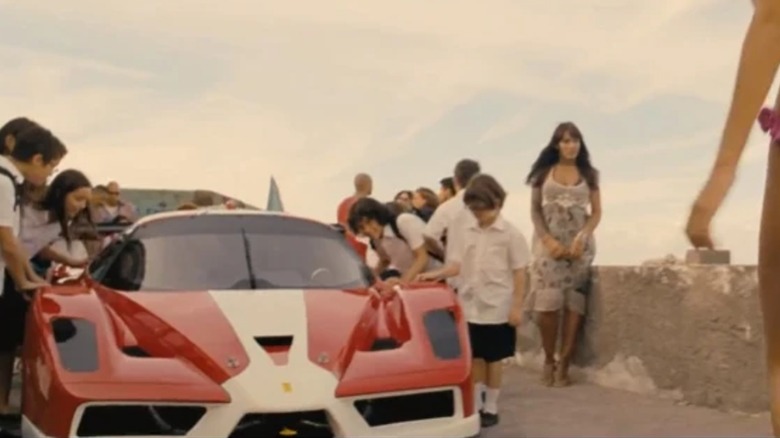 People gathered around a Ferrari FXX in "Fast & Furious 6"