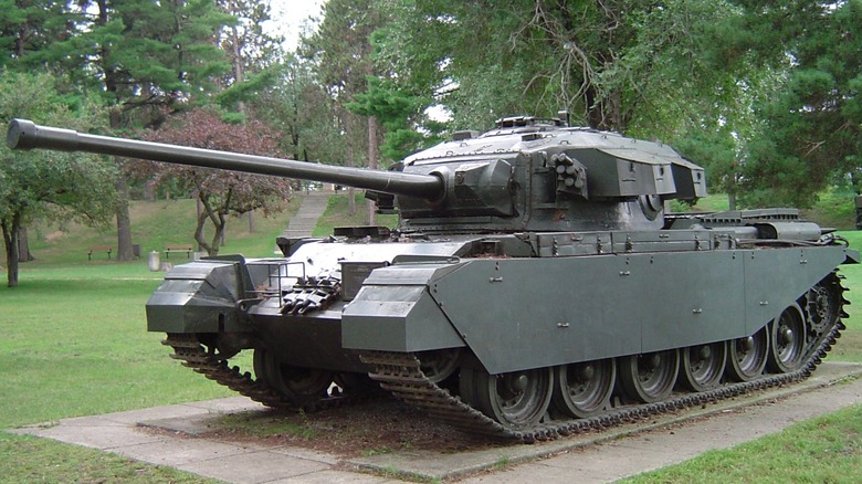 A FV4200 Centurion Main Battle Tank parked as an exhibit among some trees