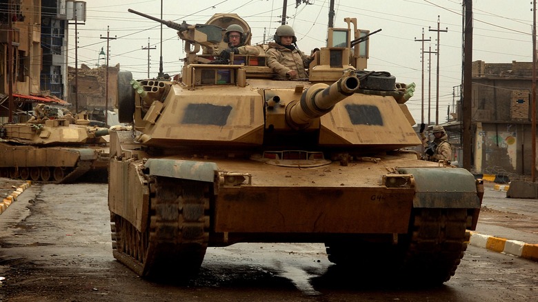 A U.S. Army M1A2 Abrams tanks maneuver through the streets of Iraq in 2005