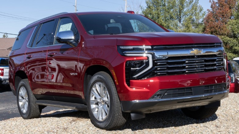 A blue 2025 Chevrolet Tahoe attached to a trailer