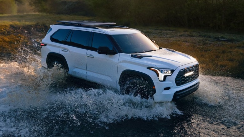A Toyota Sequoia driving through a puddle