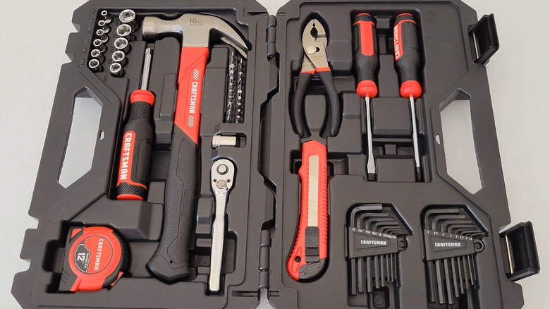 open Craftsman plastic tool box with red and black tools inside