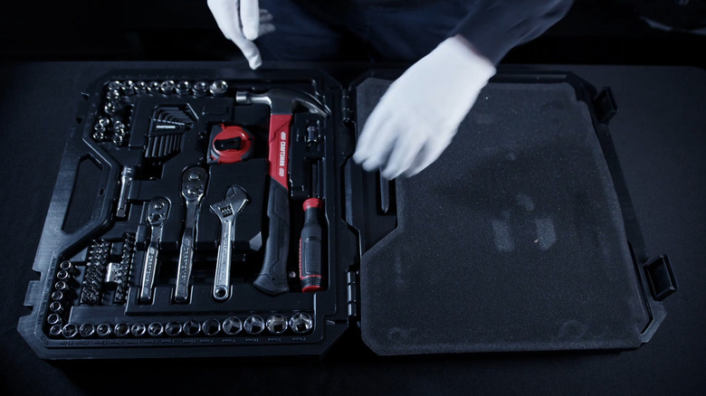 open Craftsman tool box with silver, red, and black tools inside