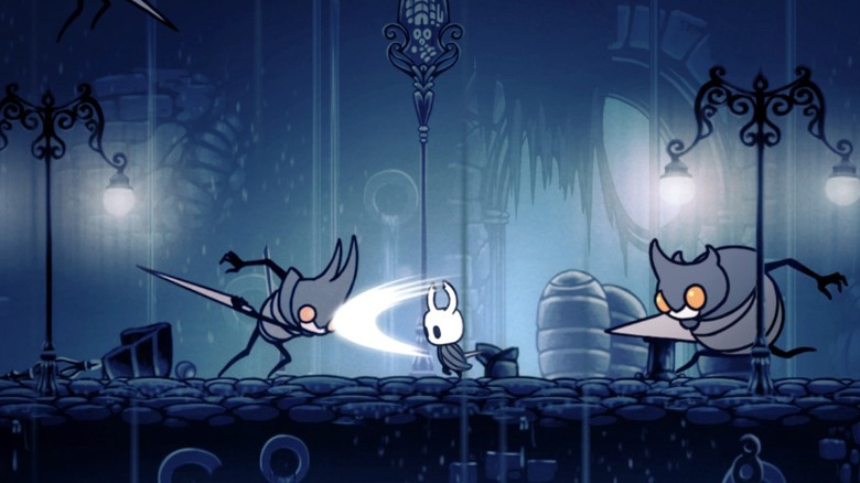 The Hollow Knight fighting two enemies