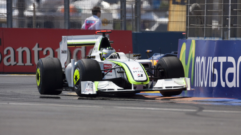 A Brawn BGP 001 car hitting a curb