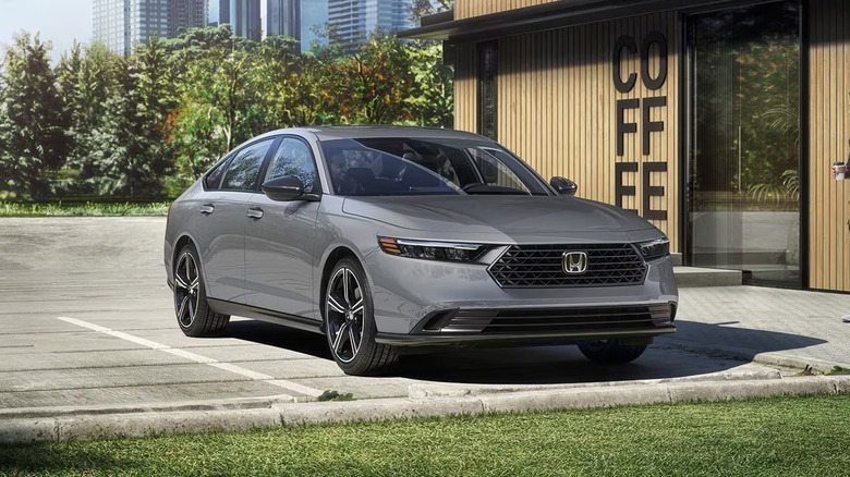 A 2026 Honda Accord finished in "Urban Gray Pearl" standing in front of a small coffee shop in the afternoon.