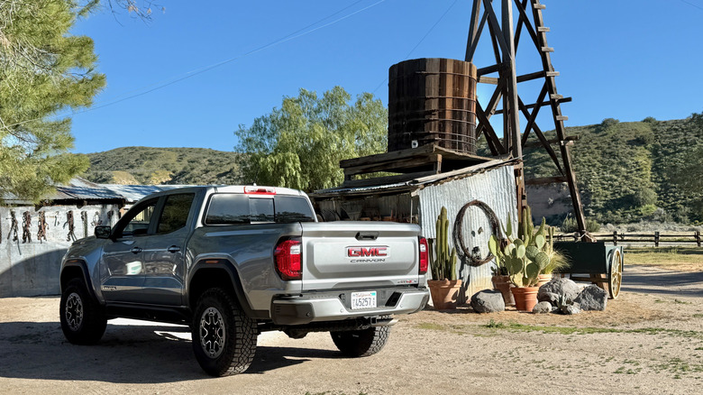 2026 GMC Canyon AT4X parked in front of a water tower