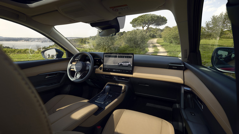 The interior of the 2026 Mazda CX-5 from the passenger side, two-tone black and tan leather trim