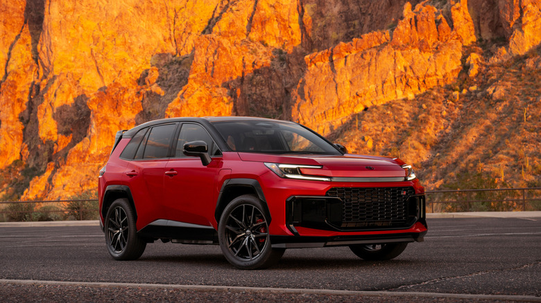 Red 2026 Toyota RAV4 GR Sport parked on desert road with cliffs in the background