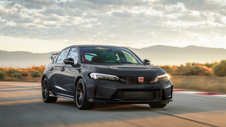 Front view of black 2027 Honda Civic Type R driving on track