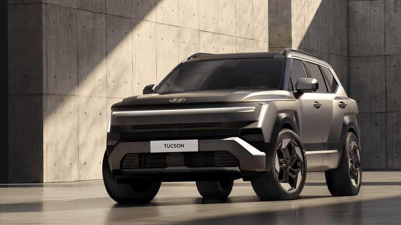 2027 Hyundai Tuscon parked inside surrounded by gray concrete walls, front-left 3/4 view