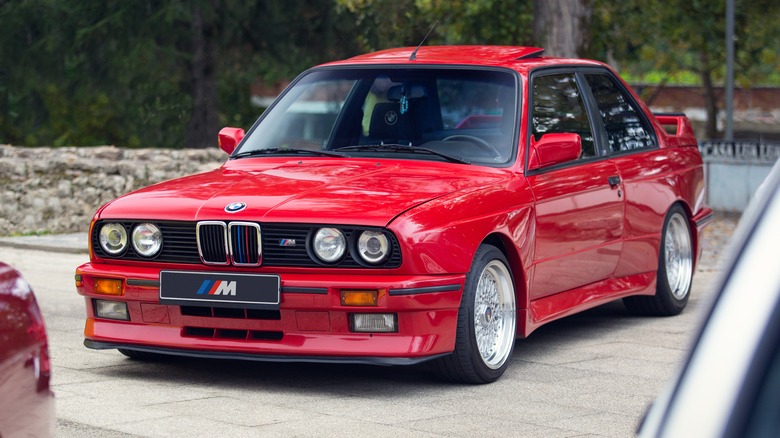 Red BMW M3 E30 at a car show