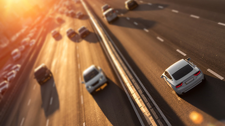 Cars moving on the highway in both directions, photographed with a tilt shift lens