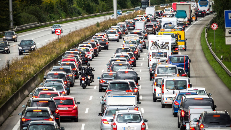 A crowded European highway with cars clogging up all three lanes