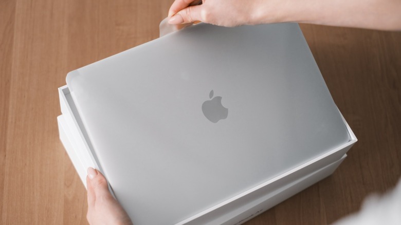 MacBook unboxing with human hands