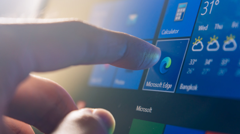 Computer user touching on Microsoft Edge