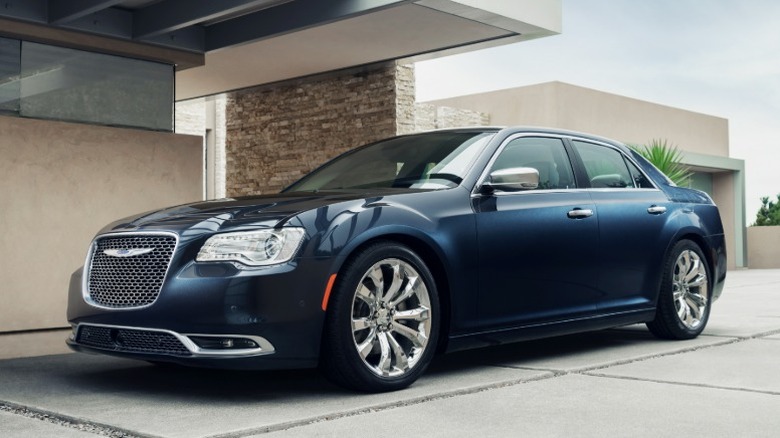 Dark blue Chrysler 300C parked in front of a house