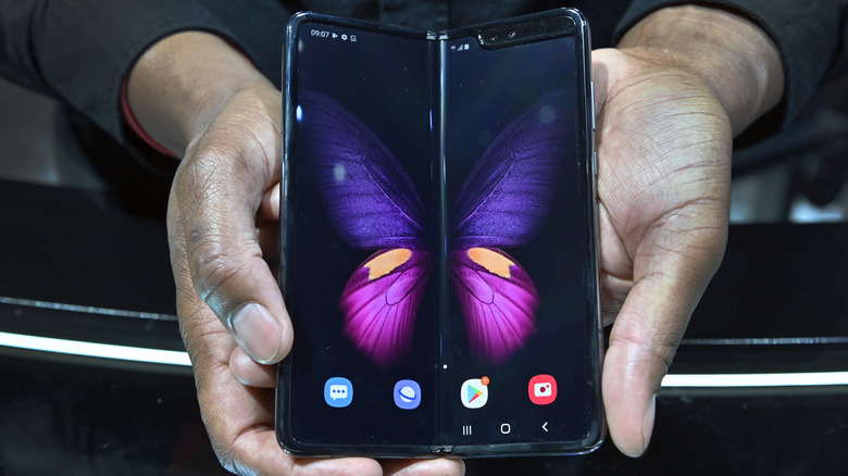 A man holding an unfolded Samsung Galaxy Fold