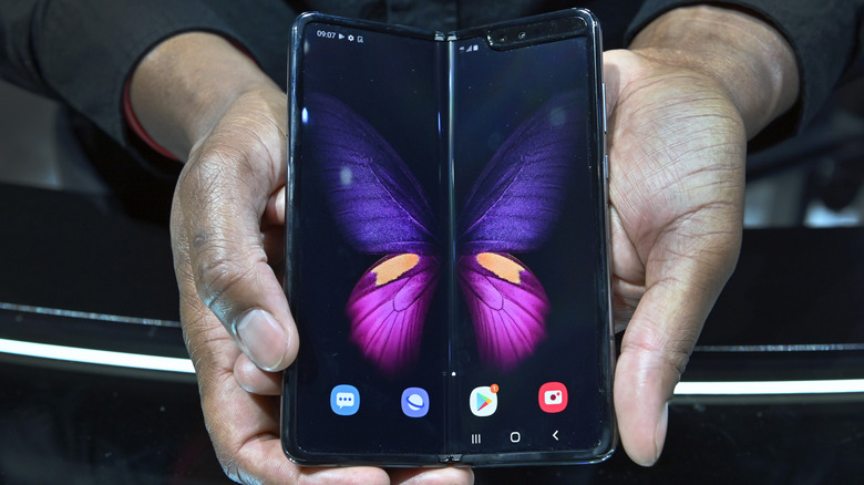 A man holding an unfolded Samsung Galaxy Fold