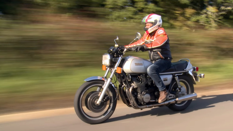 A rider in full kit on a Yamaha XS1100 on a sunny day/