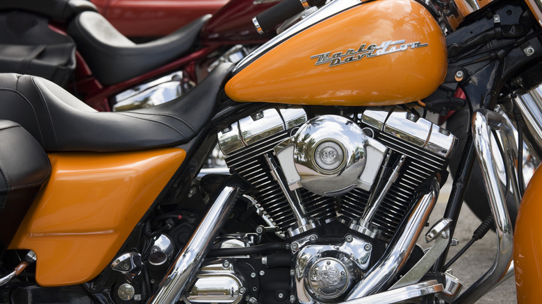 A yellow Harley Davidson Road King motorbike with the Twin Cam 88 engine parked.