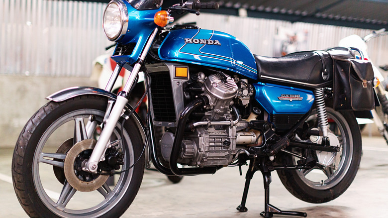 A Honda CX 500 model in blue from the late 1970s parked on its kickstand