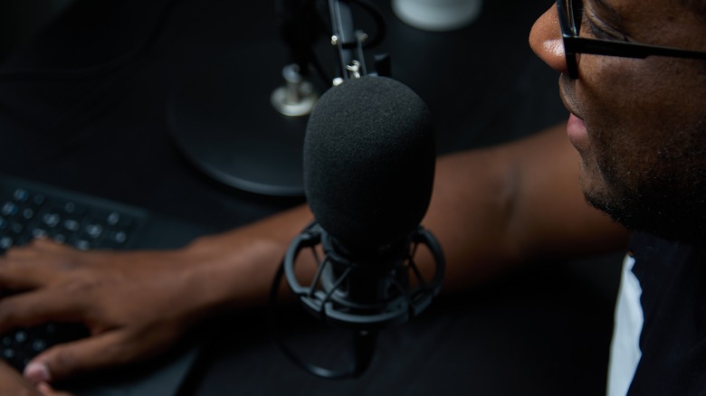 man podcasting at desk