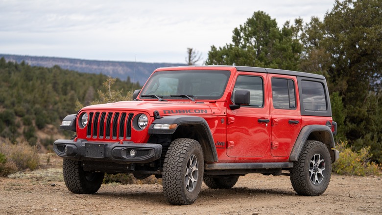 Red Jeep Wrangler on dirt road