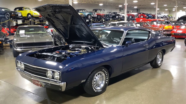 A dark blue 1969 Ford Torino Talladega in showroom floor.