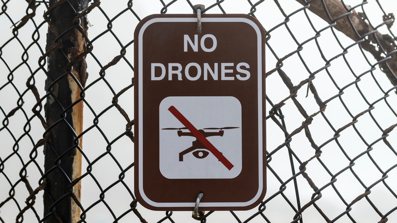 No Drones sign on chainlink fence