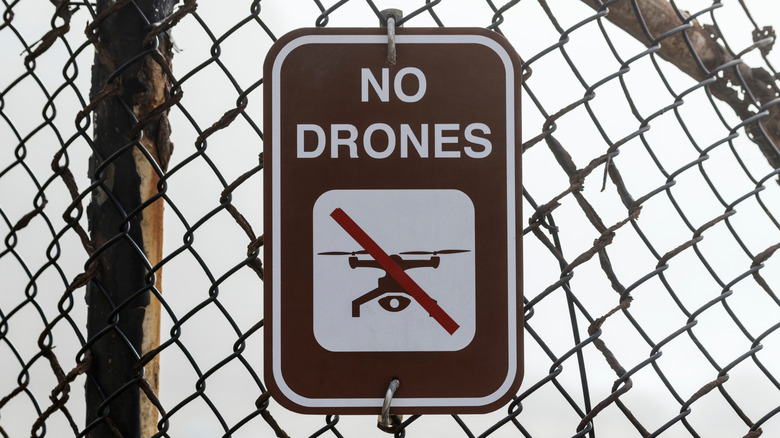No Drones sign on chainlink fence