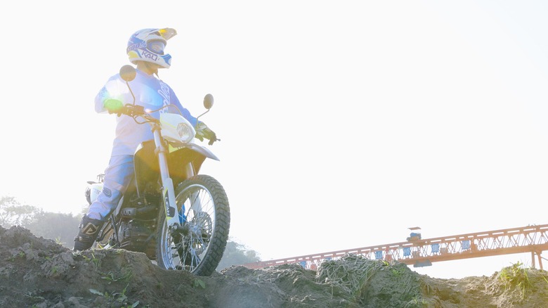 Lifan KPX 250 and rider backlit by sun