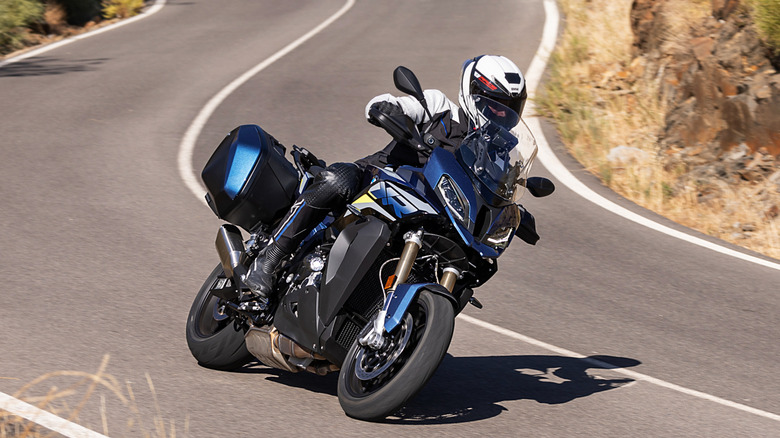 side profile view of a 2024 BMW S1000 XR riding down the road