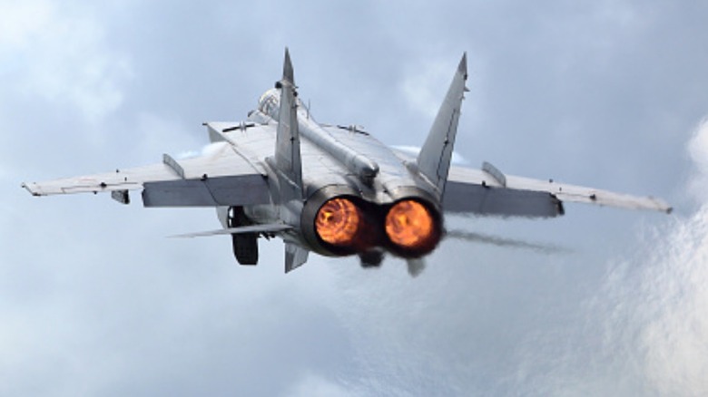 A Russian MiG-31 Foxhound taking off over cloudy skies