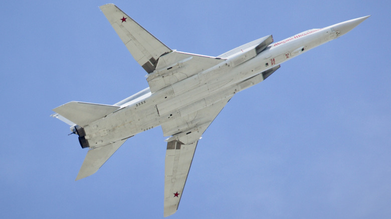 A Russian Tu-160 White Swan strategic bomber climbing over blue skies