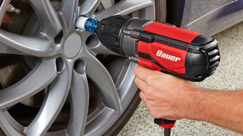 A Bauer impact wrench used on a car wheel.