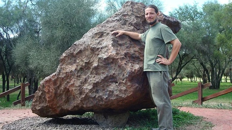 a man standing by El Chaco meteorite