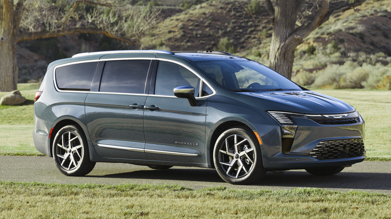 New Chrysler Pacifica minivan parked near grass
