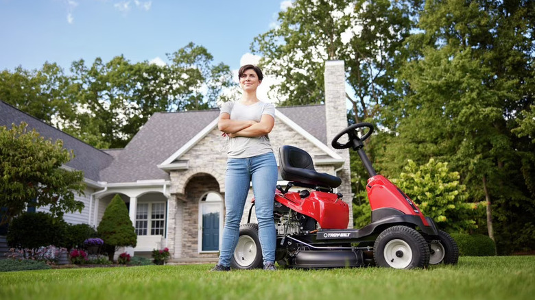 woman in front of riding mower