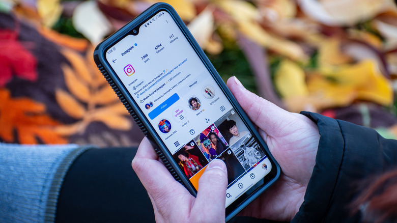 A person browsing Instagram their phone.
