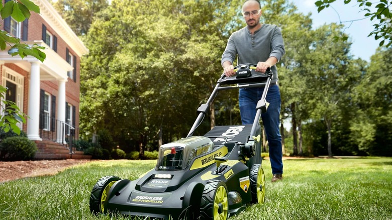 A person mowing lawn with Ryobi 40V HP Brushless 20-inch Self-Propelled Mower
