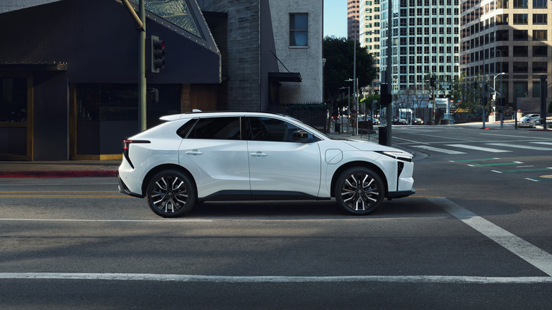 A white Toyota bZ on an empty road in a city