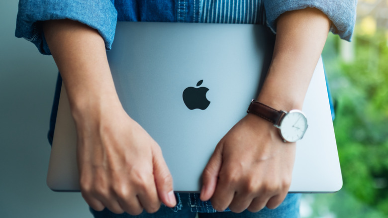 Person holding a Mac computer