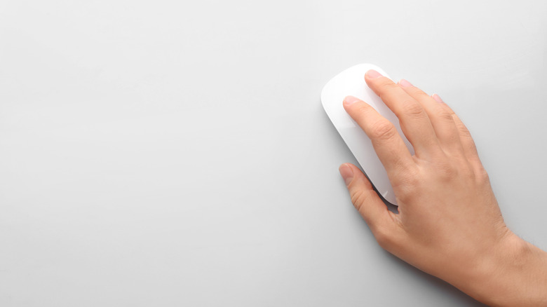 Hand clicking a mouse. 