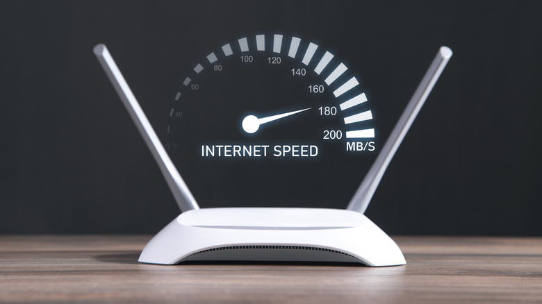 A router on a table with a graphic showing internet speed in MB/S