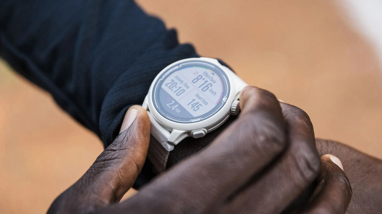 The Coros Pace 2 GPS watch being used on the left wrist of a runner.